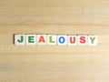 Word Jealousy on wood background