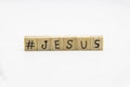 A word Jesus with hashtag. Wooden small cubes with letters isolated on white background with copy space available. Wooden cubes Royalty Free Stock Photo