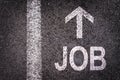 Word job and an arrow written on an asphalt road Royalty Free Stock Photo