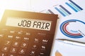 Word JOB FAIR on calculator. Business and finance concept Royalty Free Stock Photo