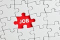 The word job written on red missing puzzle piece. To search of to find a job