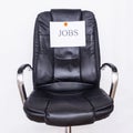 The word jobs on an office business chair. The concept of the workflow in the office, recruitment and vacancies