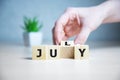 The word July on wooden cubes. Concept Month of year