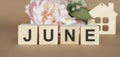The word June on wooden cubes. Concept Month