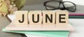 The word June on wooden cubes. Concept Month