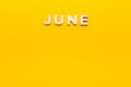 Word June on yellow background