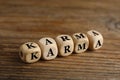 Word Karma made of cubes with letters on wooden table Royalty Free Stock Photo