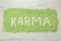 Word Karma made of sea salt on white marble table, top view Royalty Free Stock Photo