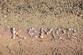 The word Kemer is laid out by pebbles on the beach of the Mediterranean Sea Royalty Free Stock Photo