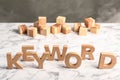 Word KEYWORD made of wooden letters on marble table