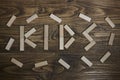 the word `kids` written on wooden table