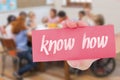 Know-how against pretty teacher helping pupils in classroom Royalty Free Stock Photo