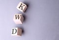 Word KWD on wooden block on the grey background Royalty Free Stock Photo