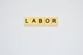 Word labor. Top view of wooden blocks with letters on white surface Royalty Free Stock Photo