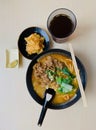 Delicious laksa beef noodle set with lemon, kimchi and lemon black tea