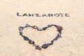 Word Lanzarote and a heart written with black stones on a beach Royalty Free Stock Photo