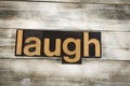 Laugh Letterpress Word on Wooden Background