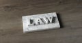 Word LAW engraved in marble wooden background 3D rendering