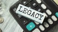 Word LEGACY on Wooden Block on calculator Royalty Free Stock Photo