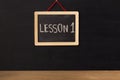 Word lesson 1 written on miniature chalkboard Royalty Free Stock Photo