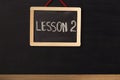 Word lesson 2 written on miniature chalkboard Royalty Free Stock Photo