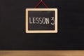 Word lesson 3 written on miniature chalkboard Royalty Free Stock Photo