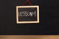 Word lesson 4 written on miniature chalkboard Royalty Free Stock Photo