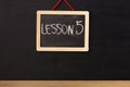 Word lesson 5 written on miniature chalkboard Royalty Free Stock Photo