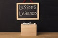 Word lessons learned written on miniature chalkboard Royalty Free Stock Photo