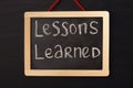 Word lessons learned written on miniature chalkboard Royalty Free Stock Photo