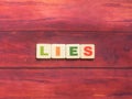 Word Lies on wood