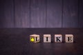 The word like and sigh thumb up on wooden cubes, on a dark background, light wooden cubes signs Royalty Free Stock Photo