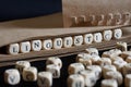 The word linguistics is made with wooden cubes next to a notebook made of eco-friendly paper. Concept of studying modern language