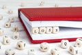 Word Loss written in wooden blocks in red notebook on white wood Royalty Free Stock Photo