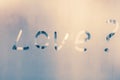 Word - LOVE? Abstract background with drops of water. Question mark. Inscription on foggy window. Handwritten text on wet glass. Royalty Free Stock Photo