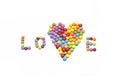 Word ``Love`` and abstract heart from bright colorful candy