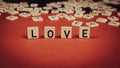 Word \"Love\" Composed Of Wooden Tiles With Letters On A Red Felt Background