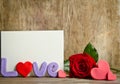 Word Love composition with empty card for text and rose near Royalty Free Stock Photo