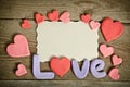 Word Love composition on the wooden board and many hearts Royalty Free Stock Photo