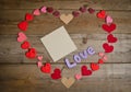 Word Love composition on the wooden board surface and many hearts Royalty Free Stock Photo