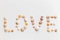 Word Love created of seashells and driftwood isolated on white background Royalty Free Stock Photo