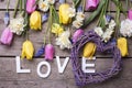 Word love, heart and bright spring tulips, narcissus, muscarie Royalty Free Stock Photo