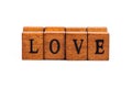 Word LOVE isolated, wooden letter rubber stamps font closeup, on white, cut out. Simple love concept text element, letters Royalty Free Stock Photo