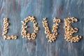 Word LOVE made with cashew nuts on wooden background Royalty Free Stock Photo