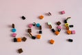 Word Love made of Colorful liquorice allsorts candy on pink background Royalty Free Stock Photo