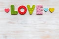 Word LOVE in wooden letters and hearts on wooden vintage backdrop. Valentines day concept Royalty Free Stock Photo