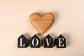 Word Love made of decorative letters and heart on wooden background Royalty Free Stock Photo