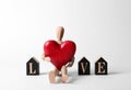 Word Love made of decorative letters, wooden mannequin and red heart Royalty Free Stock Photo