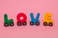 Word Love made of letters train alphabet. Bright colors of red yellow green and blue on a white background. Early childhood develo