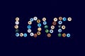 The word `Love` made from multi-colored glass balls on a dark blue background. Royalty Free Stock Photo